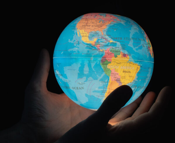 Manos-sostienen-un-mapa-mundi-con-luz-interior